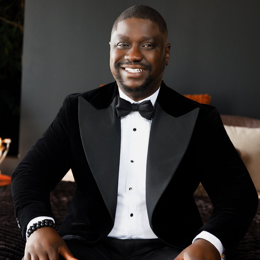 Temidayo Okeseeyin, Dayoice, smiling in a black tuxedo