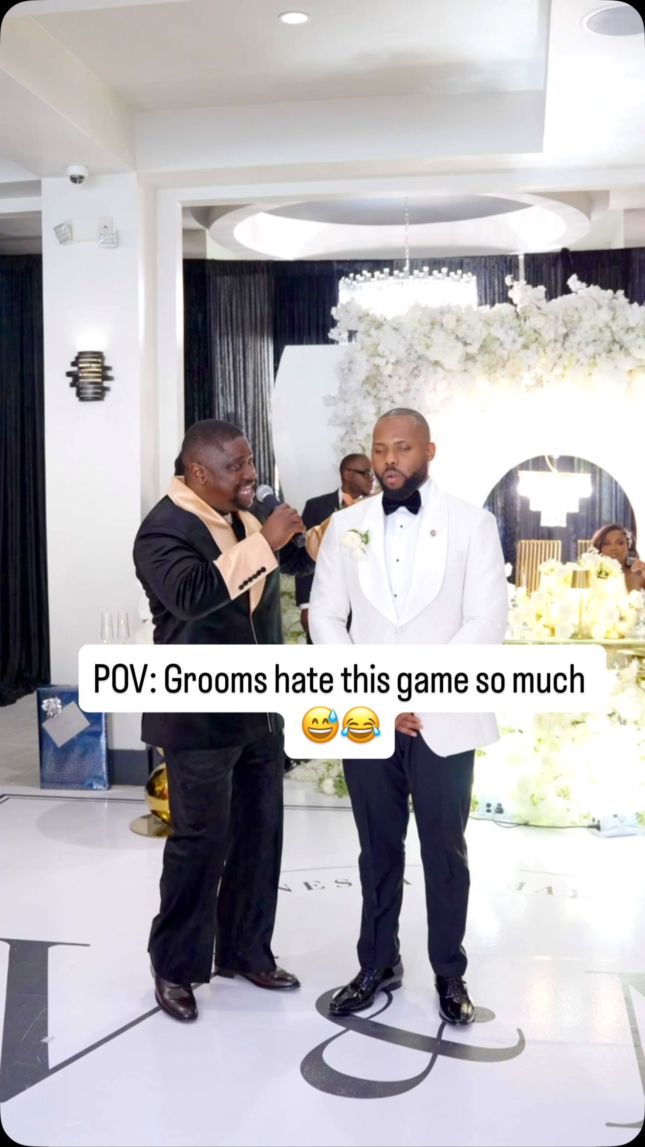 Dayoice sharing a playful moment with a groom at a wedding